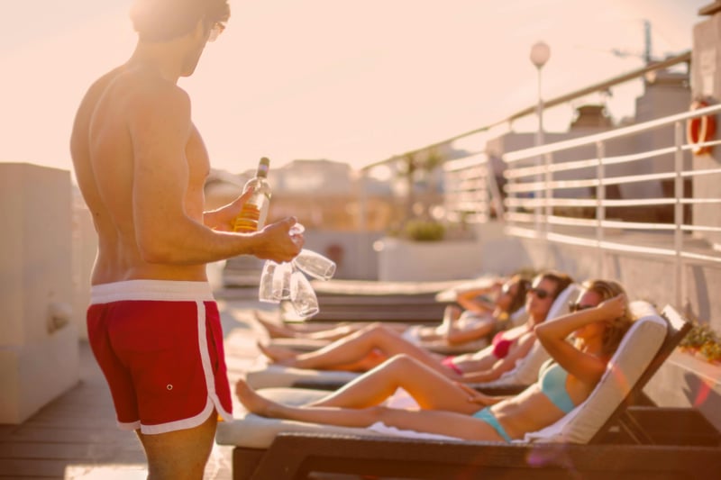 Group of young travelers sharing a drink in the sun