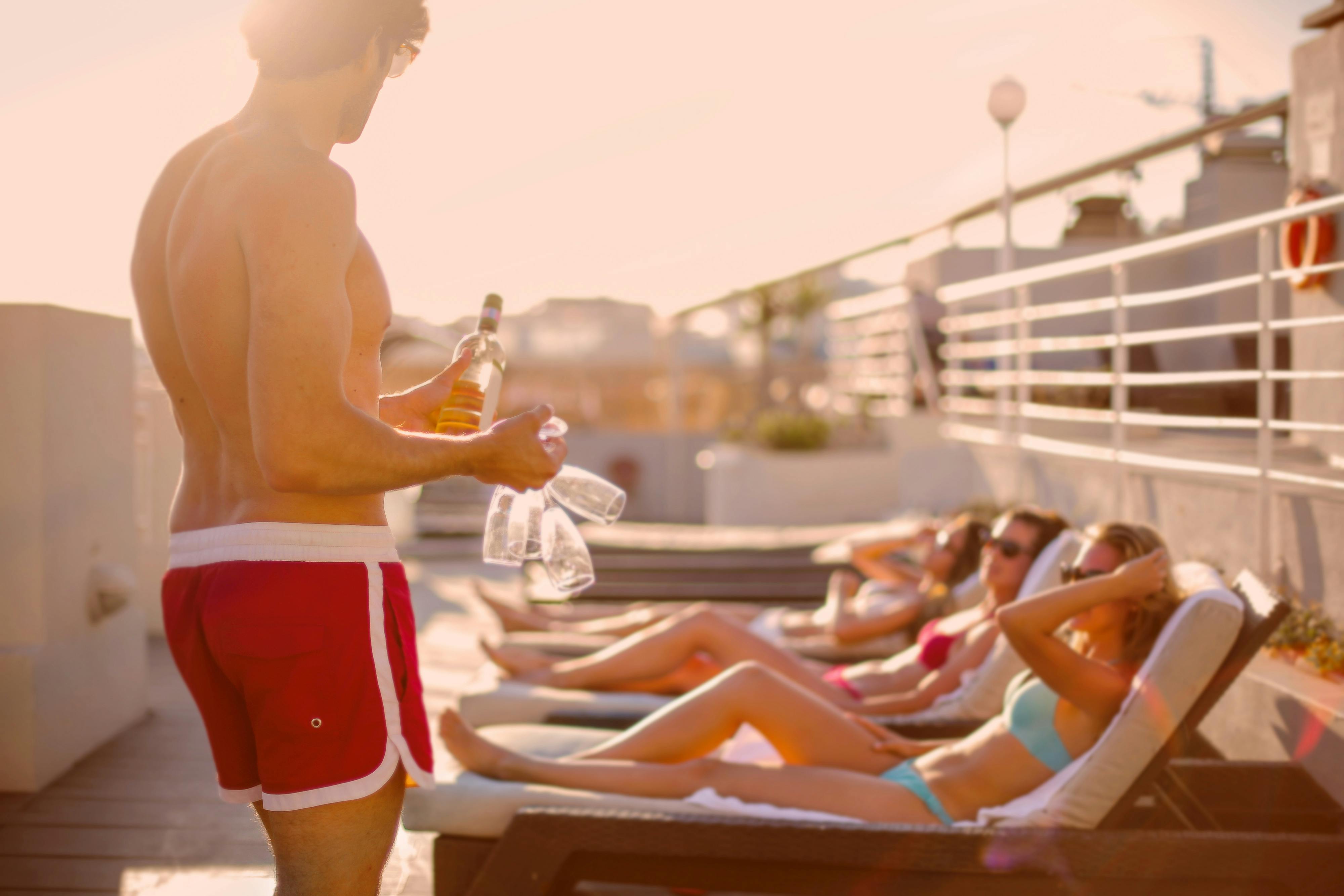 Group of young travelers sharing a drink in the sun